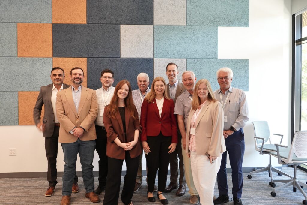 Group photo at Austin Energy. From left to right: Hammad Chaudhry, Director of Energy Efficiency, Austin Energy; Cameron Freburg, Manager of Electric Vehicles & Emerging Technologies, Austin Energy; David Logsdon, Interim Chief Customer Officer, Seattle City Light; Anna Kullmar, Chief of Staff, Austin Energy; Dennis McLerran, Deputy General Manager, Seattle City Light; Tammy Cooper, Deputy General Manager of Regulatory, Communications, Compliance & Legal Services, Austin Energy; Stuart Reilly, General Manager, Austin Energy; Michael Mann, Executive Director, Clean & Prosperous; Carol Albert, State Relations Manager; Marc Daudon, Executive Board Member, Energy Northwest. 