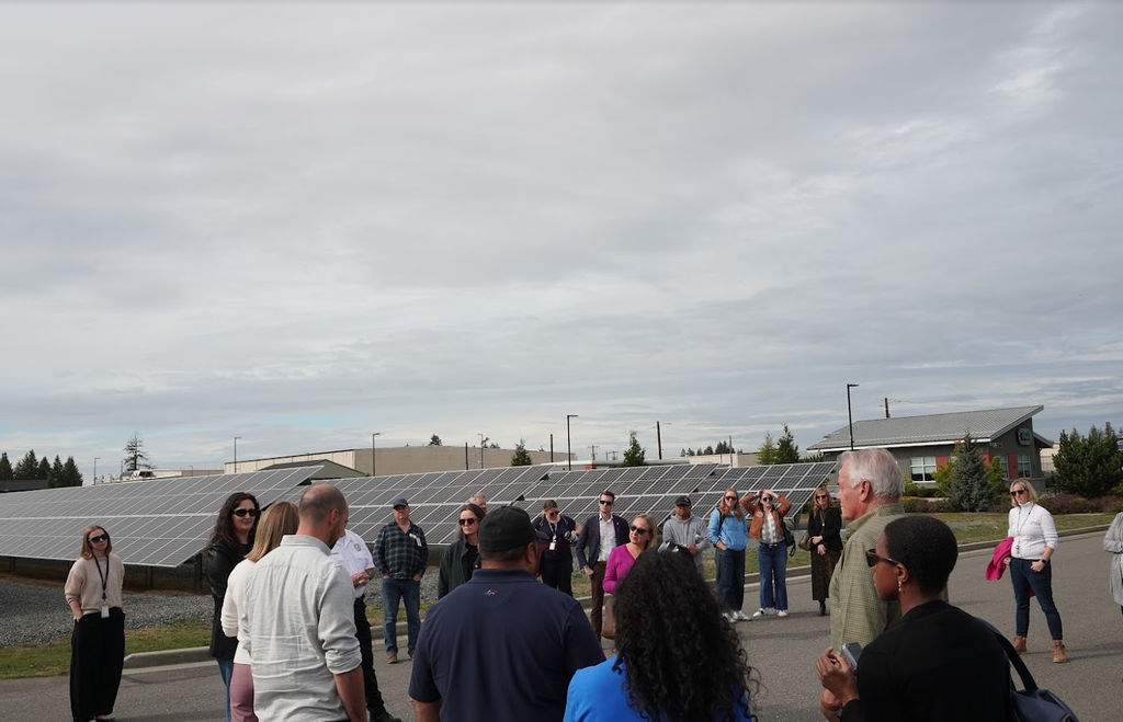 Photo of tour group including regulators, businesses, utilities, and nonprofits near solar microgrid at Snohomish County Public Utility District in Arlington, WA. 